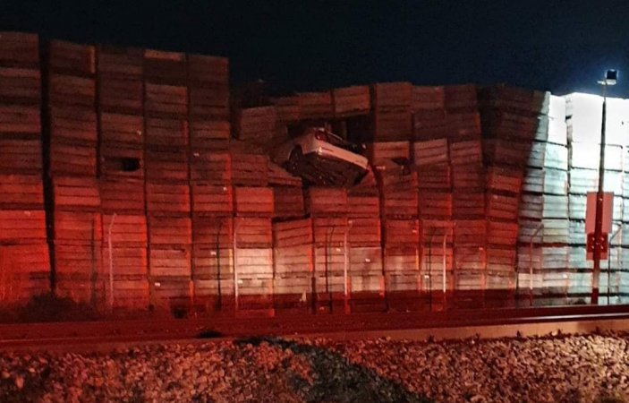 Male in 20s suffers serious injuries after car lands in orchard crates 10 metres above ground